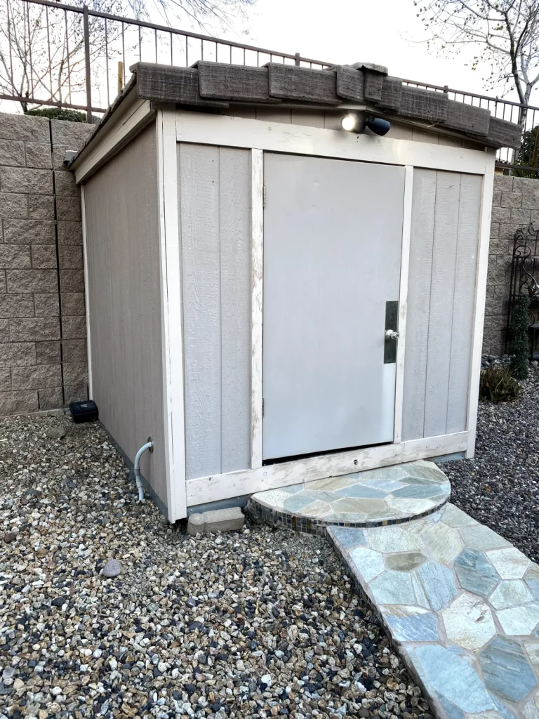Backyard storage shed on desert landscaping ready for removal