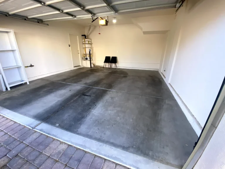 The same two-car garage completely empty after Above & Beyond hauled everything away