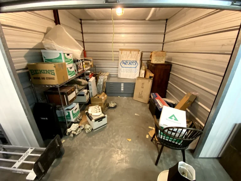 Storage unit packed with shelving, boxes and household items before cleanout