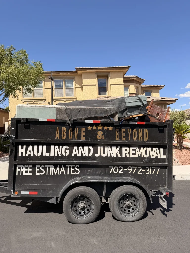 Above & Beyond dump trailer loaded with furniture outside a two-story home in Centennial Hills, Las Vegas