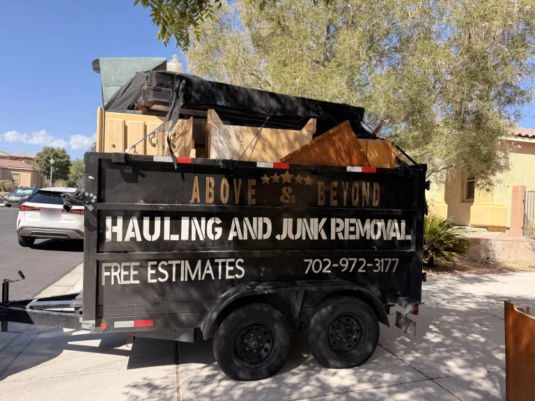 Junk removal trailer loaded with dressers and cabinets on a residential street in northwest Las Vegas